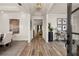 Inviting entryway featuring wood flooring, modern decor, and an open view into the dining and living areas at 301 Sobeck Way, Canton, GA 30115