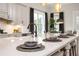 Kitchen island with a white countertop, seating, and modern fixtures, perfect for casual dining at 301 Sobeck Way, Canton, GA 30115