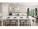 Kitchen island with bar seating, modern pendant lights, and grey cabinetry at 301 Sobeck Way, Canton, GA 30115