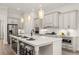 Open kitchen design with a center island, breakfast bar seating, and stainless steel appliances at 301 Sobeck Way, Canton, GA 30115