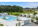 Inviting pool area with cabanas and lounge chairs surrounded by lush landscaping and trees at 301 Sobeck Way, Canton, GA 30115