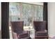 Bright sitting area with comfortable chairs, hardwood floors, and large windows with scenic views at 301 Sobeck Way, Canton, GA 30115