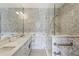 Elegant bathroom features marble countertop and shower with decorative geometric patterned tiles at 2660 Peachtree Nw Rd # 4G, Atlanta, GA 30305
