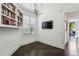 Bedroom showcases hardwood floors, built-in bookshelves, plantation shutters and a TV on the wall at 2660 Peachtree Nw Rd # 4G, Atlanta, GA 30305