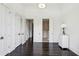 Bright hallway with dark hardwood floors, neutral walls, and view into a luxurious bathroom at 2660 Peachtree Nw Rd # 4G, Atlanta, GA 30305