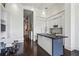 Contemporary kitchen with white cabinets, island, and adjacent dining area at 2660 Peachtree Nw Rd # 4G, Atlanta, GA 30305