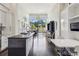Modern kitchen with island, sleek white cabinets, and floor to ceiling windows at 2660 Peachtree Nw Rd # 4G, Atlanta, GA 30305