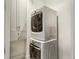 Functional laundry room with stacked washer and dryer, plus built-in shelving at 2660 Peachtree Nw Rd # 4G, Atlanta, GA 30305