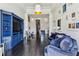 Open-concept floor plan with stylish living room, hardwood floors, and view of the kitchen at 2660 Peachtree Nw Rd # 4G, Atlanta, GA 30305
