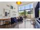 Elegant living room with large windows, blue couch, hardwood flooring and stylish decor at 2660 Peachtree Nw Rd # 4G, Atlanta, GA 30305