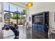 Bright living room with hardwood floors, large windows, blue sofa, and outdoor patio at 2660 Peachtree Nw Rd # 4G, Atlanta, GA 30305