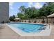 Sparkling pool area surrounded by lush greenery and comfortable lounging options at 2660 Peachtree Nw Rd # 4G, Atlanta, GA 30305