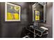 Modern powder room featuring a glass sink, sleek mirror, and artistic accents at 2660 Peachtree Nw Rd # 4G, Atlanta, GA 30305