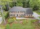 Aerial view of a brick two-story home with a landscaped yard and a driveway at 4979 Shadow Glen Ct, Dunwoody, GA 30338