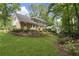 Expansive backyard featuring lush landscaping, a patio, and wooded views at 4979 Shadow Glen Ct, Dunwoody, GA 30338