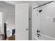 Bathroom featuring a shower with white subway tile, dark fixtures, and a peek at the staircase at 4979 Shadow Glen Ct, Dunwoody, GA 30338