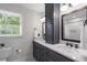 Bathroom featuring double sinks, dark wood cabinets, white countertops and a shower with white subway tile at 4979 Shadow Glen Ct, Dunwoody, GA 30338