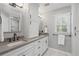 Elegant bathroom with double sink vanity, quartz counters, updated fixtures and framed mirror at 4979 Shadow Glen Ct, Dunwoody, GA 30338