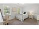 Bright bedroom featuring white walls, a sleigh bed, and two windows with a scenic outdoor view at 4979 Shadow Glen Ct, Dunwoody, GA 30338