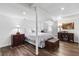 Comfortable bedroom with wood-look floors and warm lighting at 4979 Shadow Glen Ct, Dunwoody, GA 30338