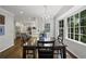 Open dining room with hardwood floors, natural light, a dark wooden table and kitchen access at 4979 Shadow Glen Ct, Dunwoody, GA 30338