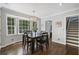 Dining room with hardwood floors, natural light, a dark wooden table and modern chandelier at 4979 Shadow Glen Ct, Dunwoody, GA 30338