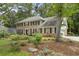 Elegant two-story brick home with mature trees and landscaping, showcasing classic architectural details at 4979 Shadow Glen Ct, Dunwoody, GA 30338