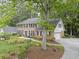 Charming two-story brick home with a well-manicured lawn, mature landscaping, and a long driveway at 4979 Shadow Glen Ct, Dunwoody, GA 30338