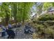 Secluded backyard firepit surrounded by mature trees and landscaping at 4979 Shadow Glen Ct, Dunwoody, GA 30338