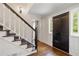 Elegant foyer with hardwood floors, a staircase, and a stylish front door, creating a grand entrance at 4979 Shadow Glen Ct, Dunwoody, GA 30338