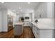 Modern kitchen with stainless steel appliances, white cabinetry, a kitchen island, and hardwood floors at 4979 Shadow Glen Ct, Dunwoody, GA 30338