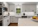 Bright kitchen features white cabinets, subway tile backsplash, stainless appliances, and marble countertops at 4979 Shadow Glen Ct, Dunwoody, GA 30338