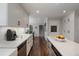 Bright eat-in kitchen features a white cabinets, island, stainless appliances, and hardwood floors at 4979 Shadow Glen Ct, Dunwoody, GA 30338