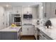 Bright kitchen with island, stainless appliances, white cabinets and hardwood floors at 4979 Shadow Glen Ct, Dunwoody, GA 30338