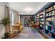 Inviting home library featuring floor to ceiling bookcases and a cozy seating area at 4979 Shadow Glen Ct, Dunwoody, GA 30338