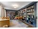 Cozy library with floor-to-ceiling bookshelves, a comfortable seating area, and plenty of natural light at 4979 Shadow Glen Ct, Dunwoody, GA 30338