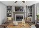 Living room featuring a fireplace with built-in shelving and comfortable seating at 4979 Shadow Glen Ct, Dunwoody, GA 30338