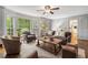 Bright living room with a bay window, hardwood floors, and comfortable seating arrangements at 4979 Shadow Glen Ct, Dunwoody, GA 30338