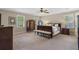 Spacious main bedroom featuring large windows, ceiling fan and a comfortable sitting area at 4979 Shadow Glen Ct, Dunwoody, GA 30338