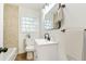Bright bathroom features updated fixtures, tiled walls, and a modern sink at 1258 Lyle Ave, Atlanta, GA 30344