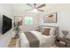 Relaxing bedroom features modern decor, a ceiling fan, and a view of the outdoors at 1258 Lyle Ave, Atlanta, GA 30344