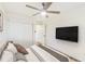 Bright bedroom featuring a ceiling fan, wall-mounted TV, and closet at 1258 Lyle Ave, Atlanta, GA 30344