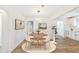 Bright dining area with wood table, stylish lighting fixture, and white wainscoting at 1258 Lyle Ave, Atlanta, GA 30344