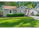 Charming one-story home featuring a manicured lawn, mature trees, and inviting entrance at 1258 Lyle Ave, Atlanta, GA 30344