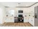 Updated kitchen features stainless appliances, white cabinets, and subway tile backsplash at 1258 Lyle Ave, Atlanta, GA 30344