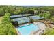 Aerial view of swimming pools and tennis courts surrounded by lush greenery at 357 Ridgewood Trl, Canton, GA 30115