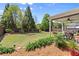 Large backyard featuring covered patio, lush lawn, landscaping and a wooden fence at 357 Ridgewood Trl, Canton, GA 30115