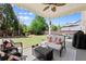 Inviting backyard patio with seating, string lights, ceiling fan, and beautifully landscaped lawn at 357 Ridgewood Trl, Canton, GA 30115