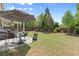Lush backyard with patio, umbrella, outdoor seating, green lawn and wooden fence at 357 Ridgewood Trl, Canton, GA 30115