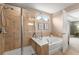 Bathroom featuring a soaking tub, walk-in shower, and large framed mirror at 357 Ridgewood Trl, Canton, GA 30115